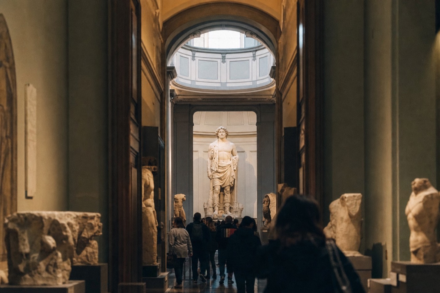 Michelangelo's David seen down the long corridor of the Accademia Gallery in Florence, lit by the skylight of the Tribune